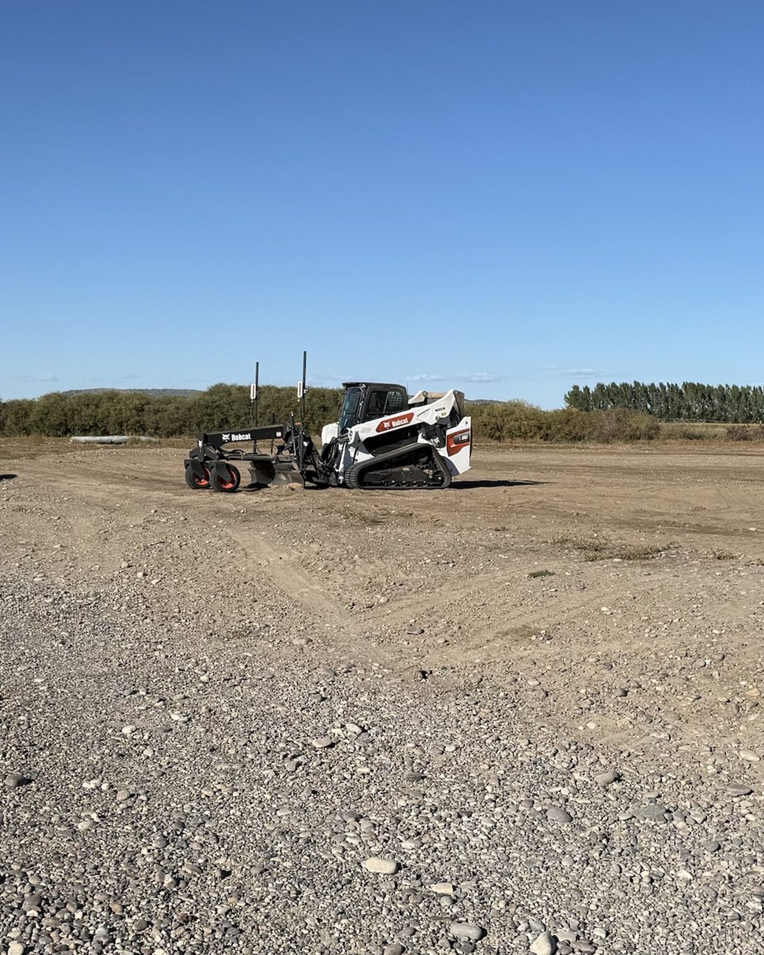 Laser-guided grading on a large lot with the skid steer