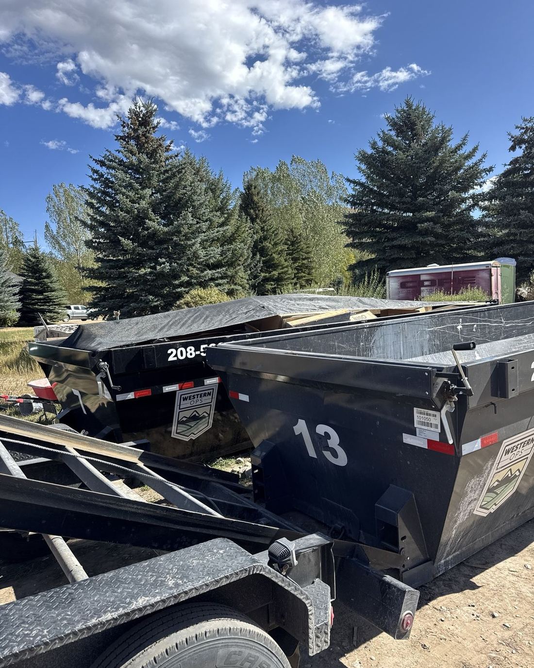 Loaded and tarped roll-off cans headed for the dump from the Shelley area