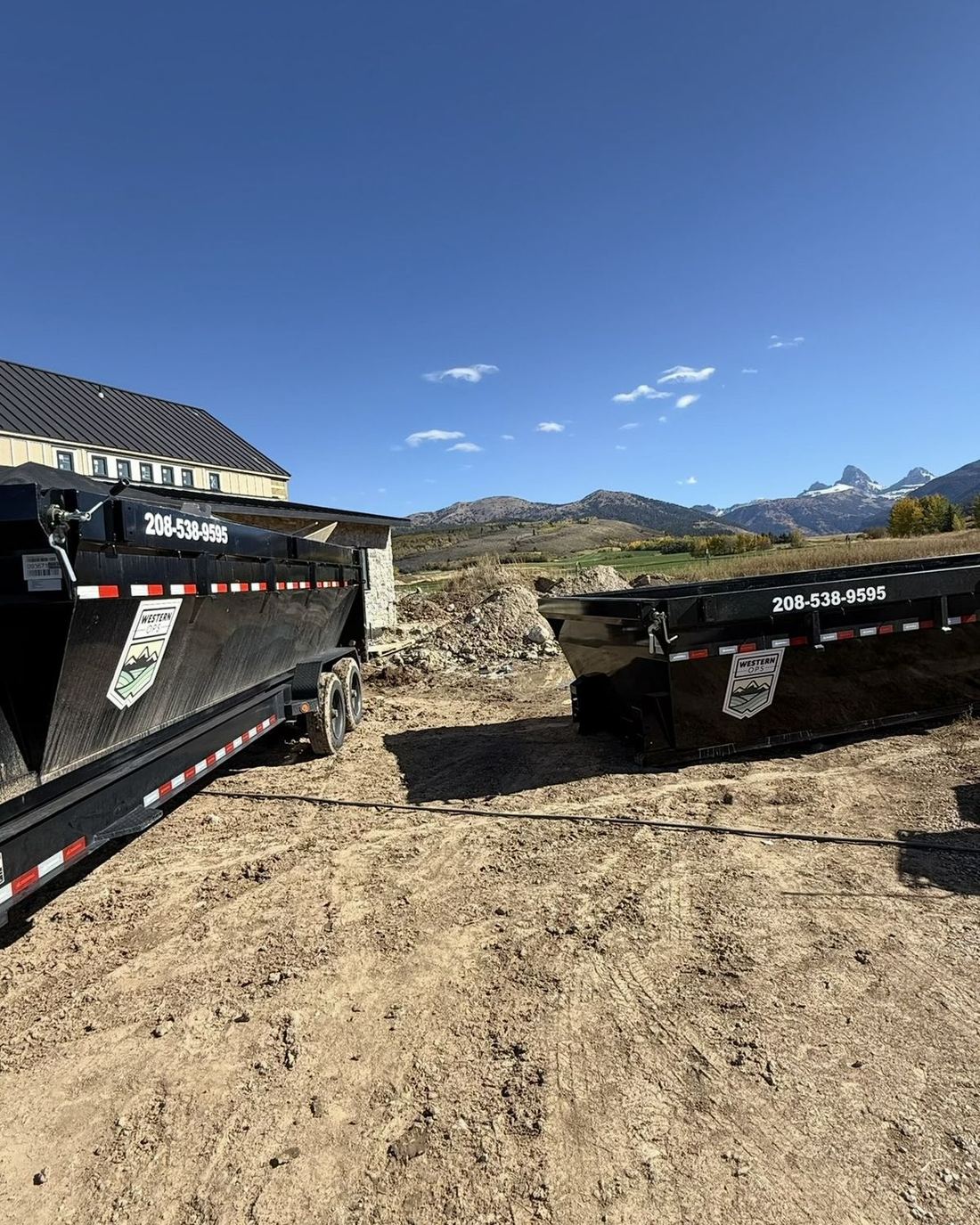 Western Ops dumpsters on a job site with the Tetons behind - Driggs and Victor country